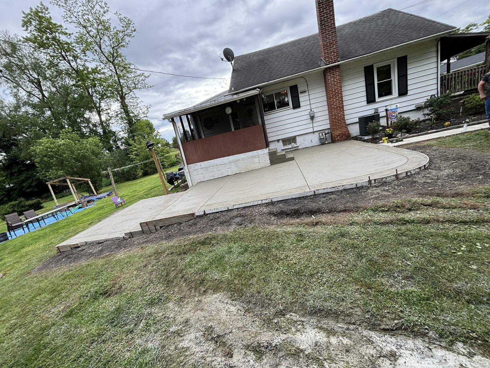Curved backyard patio completed by T-Bones Concrete