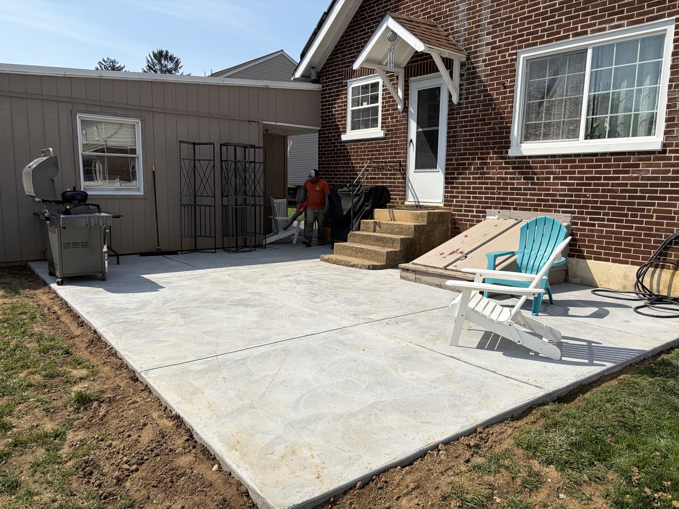 Broom-finish backyard patio completed by T-Bones Concrete