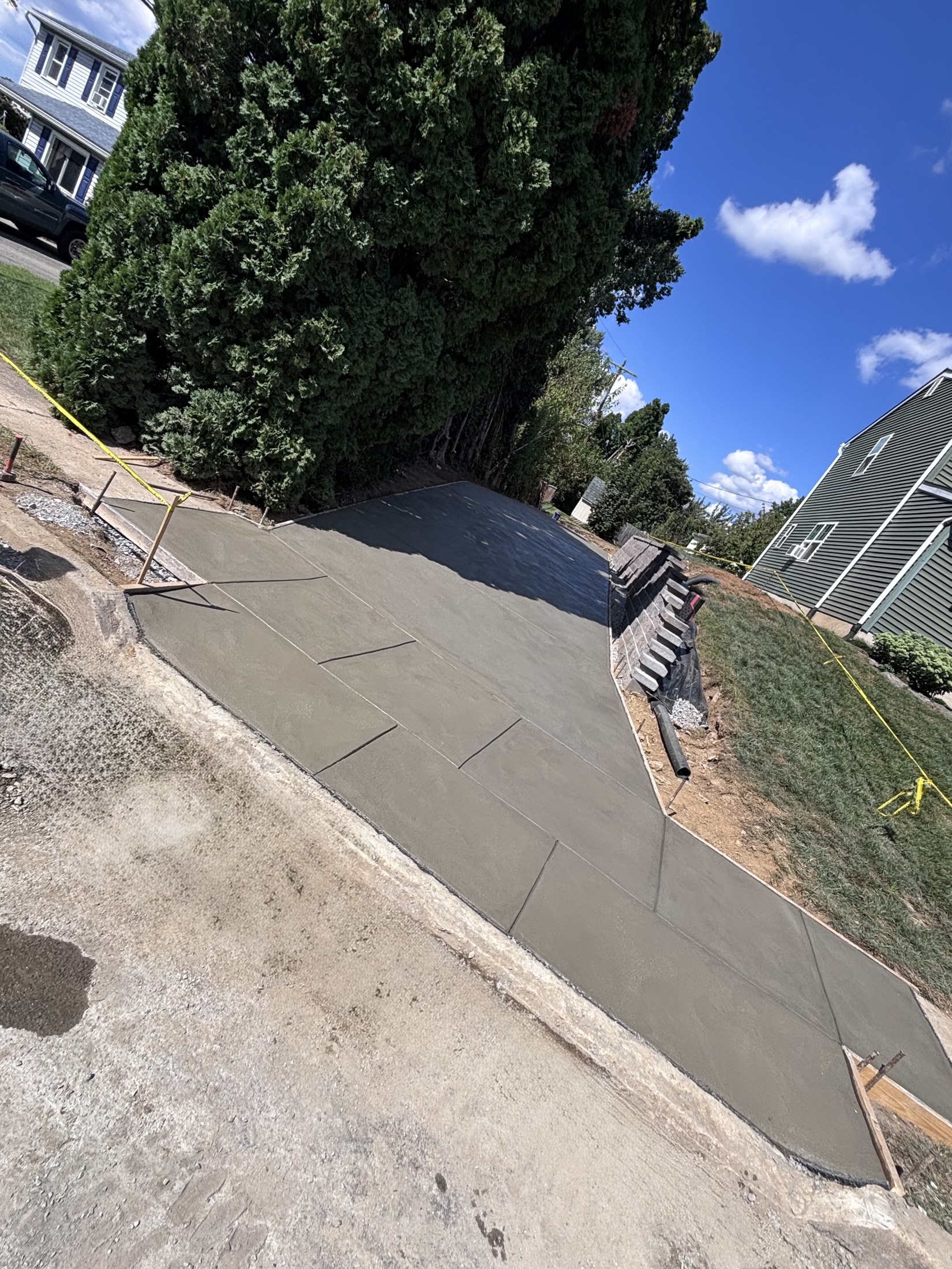 Fresh concrete side-yard pad completed by T-Bones Concrete